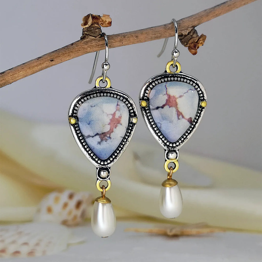 Retro blue women's drop earrings with geometric shape, synthetic opal and pearl details on electroplated metal.