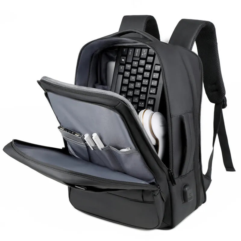 Men's large capacity waterproof backpack in black or grey with curved shoulder strap for business travel