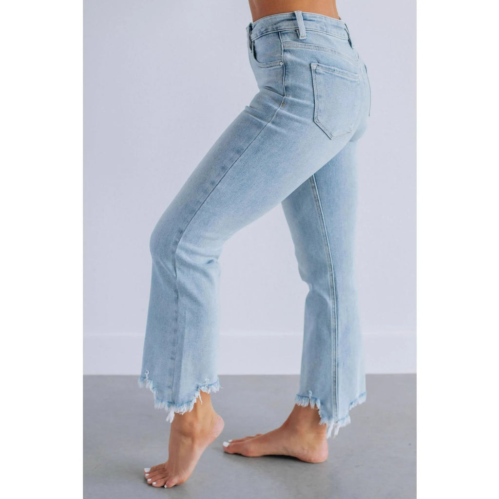 Women's solid colour denim jeans with hand-worn distressing in dark blue on a model
