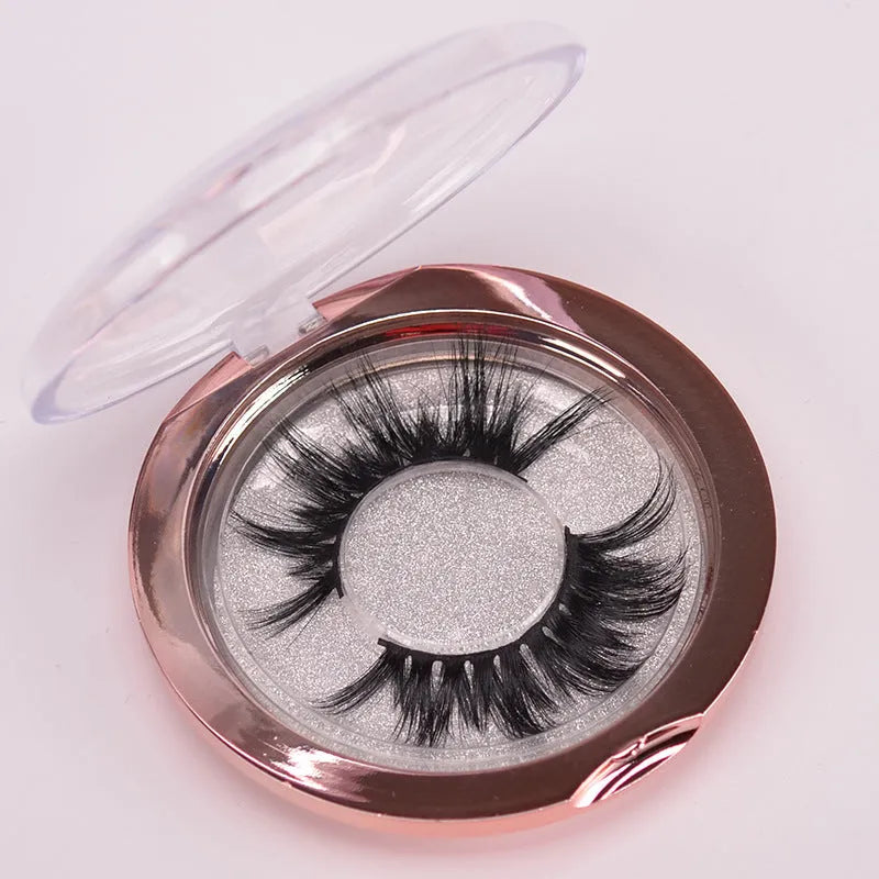 Handmade 5D mink false eyelashes set with storage case and double-headed brush on a clean background.