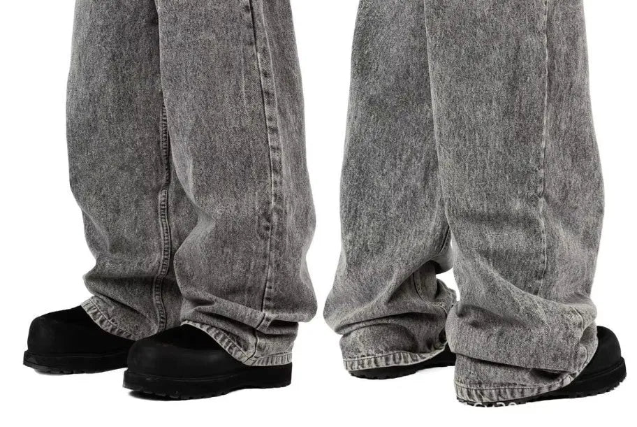 Grey loose straight-leg denim trousers showing mid-waist design on mannequin