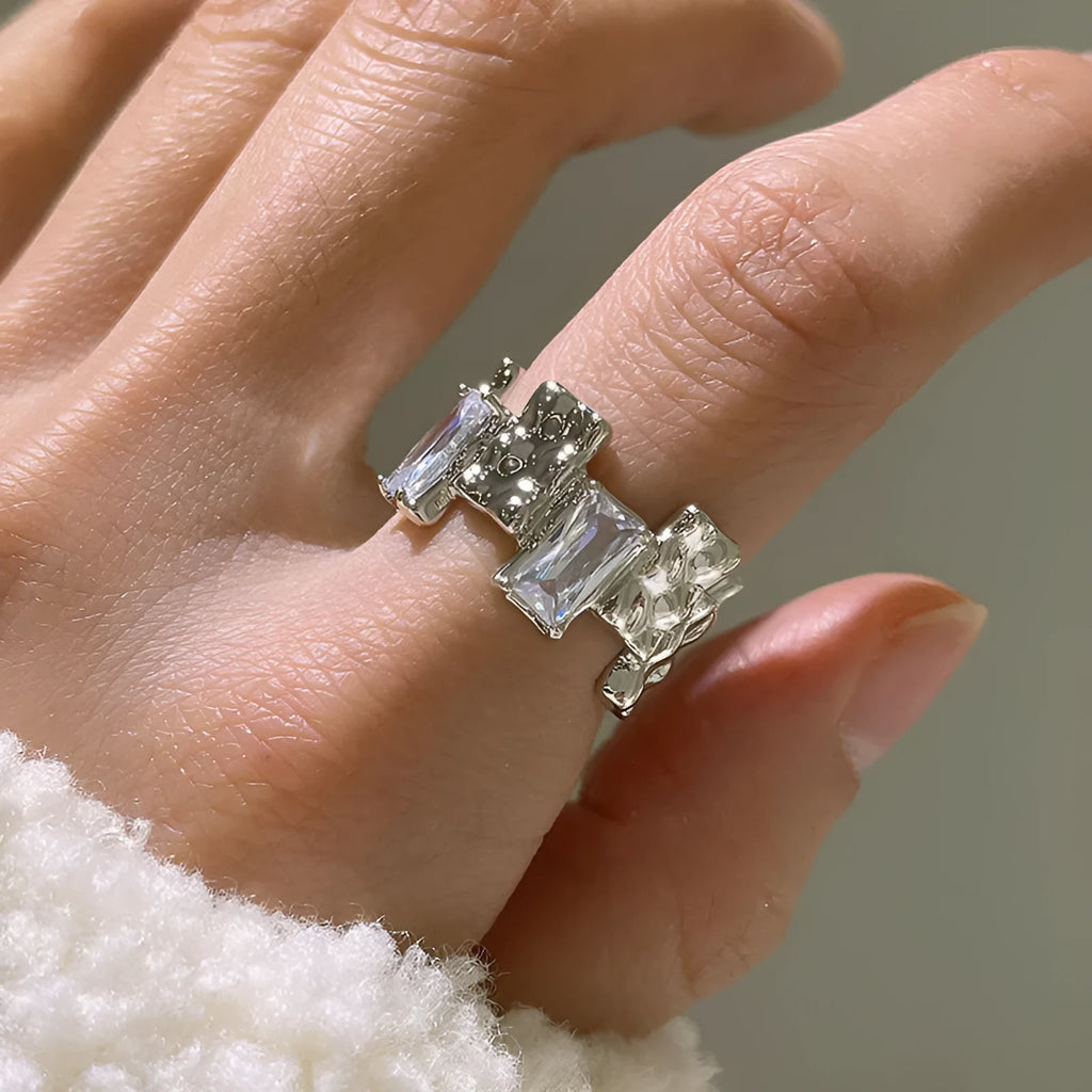 Silver geometric cross ring with open zircon gemstone setting and three-dimensional decoration