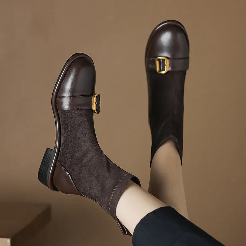 Women's black low-heel Martin boots with lace-up front and decorative belt buckle stitching.