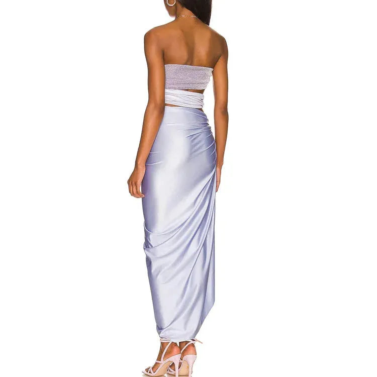 Purple hollow one-piece swimsuit with matching wrap skirt on a model.