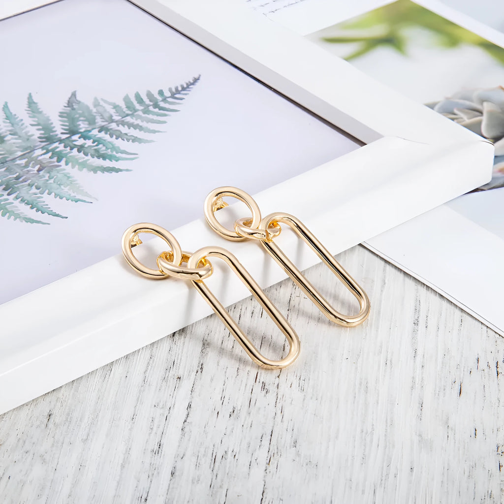 Geometric sterling silver needle hoop earrings with ring and line design details