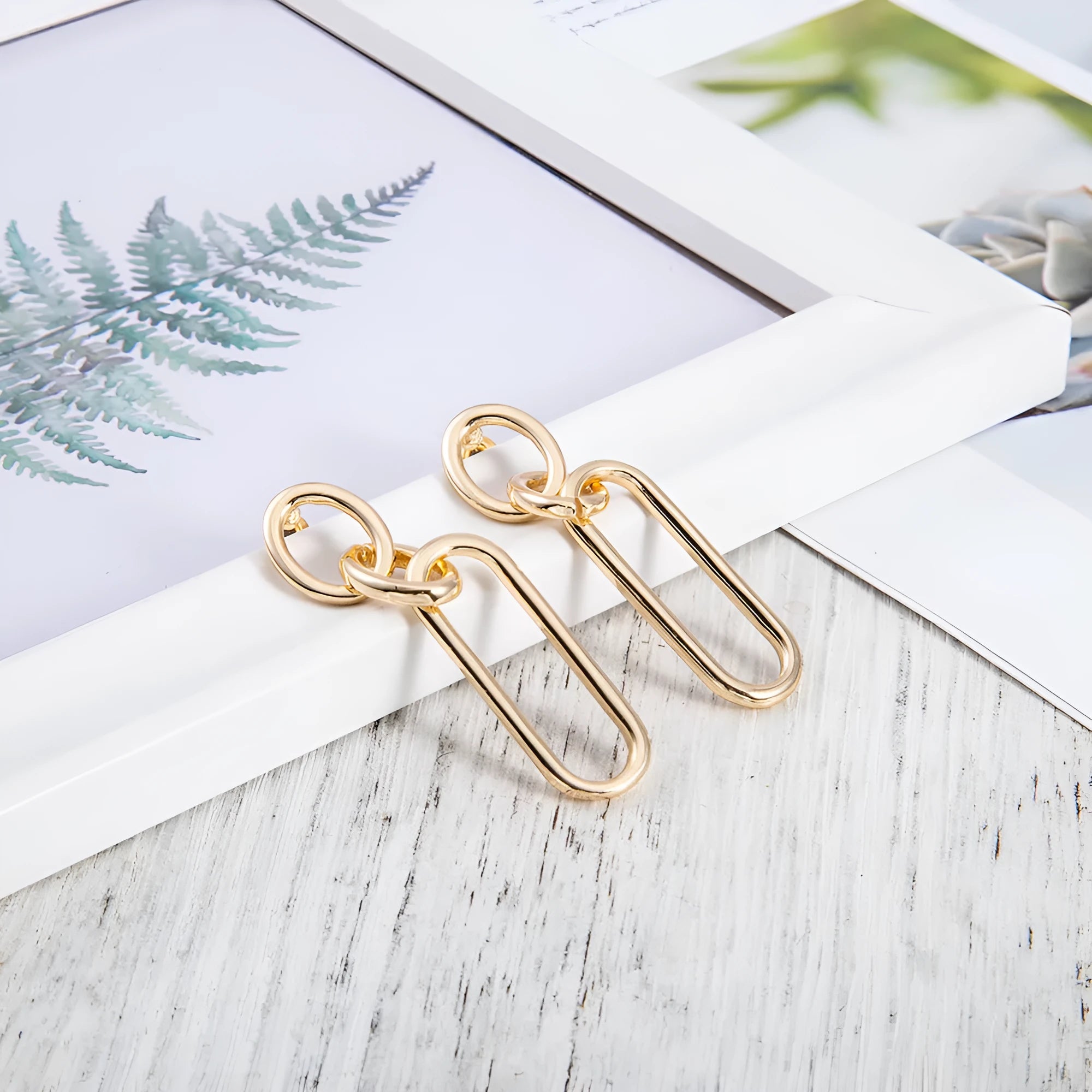 Geometric sterling silver needle hoop earrings with ring and line design details