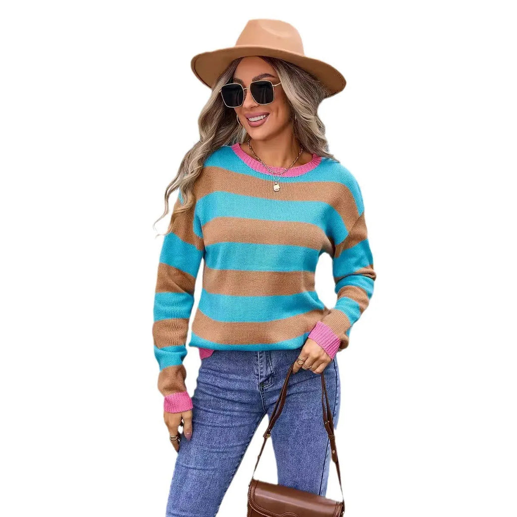 Women's loose fit long sleeve striped sweater in blue colour on a hanger.