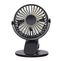 A white portable clip fan with plastic blades, showing its USB charging port and piano button switch.