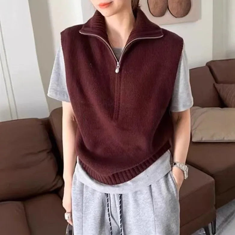 Woman's sleeveless half-zip knit vest with a 3D textured pattern in a solid colour.