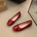Retro apricot colour Mary Jane ballet flats with bow detail and square toe on a white background.