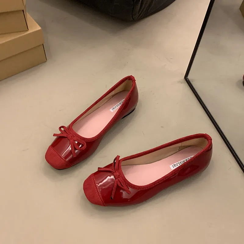 Retro apricot colour Mary Jane ballet flats with bow detail and square toe on a white background.