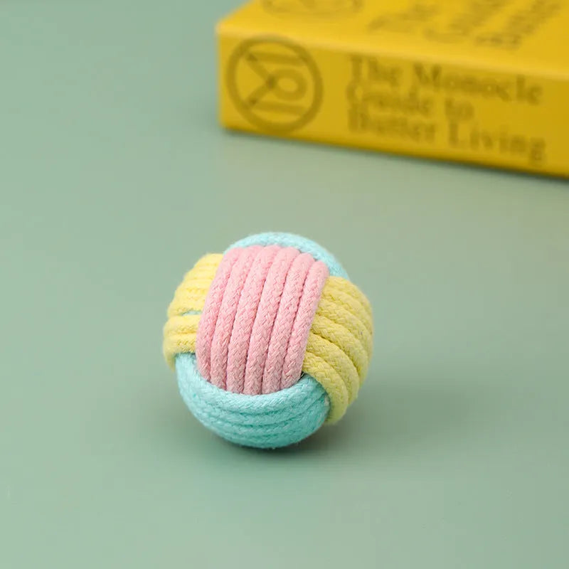 Handmade blue powder and green plush cotton ball cat toy for teeth grinding and play.