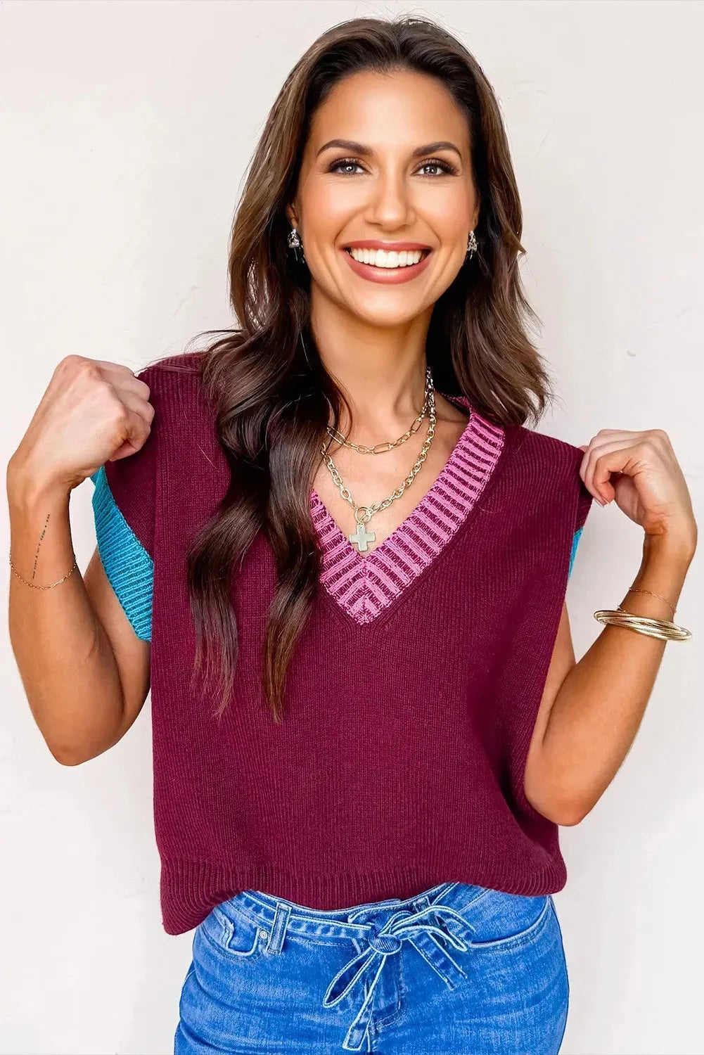 Burgundy women's V-neck sweater with contrast trim and cuffed short sleeves on hanger