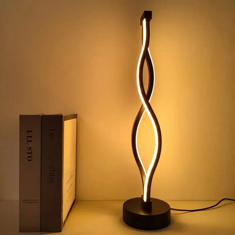 Black aluminium desk lamp with touch dimming button showing three colour temperature settings