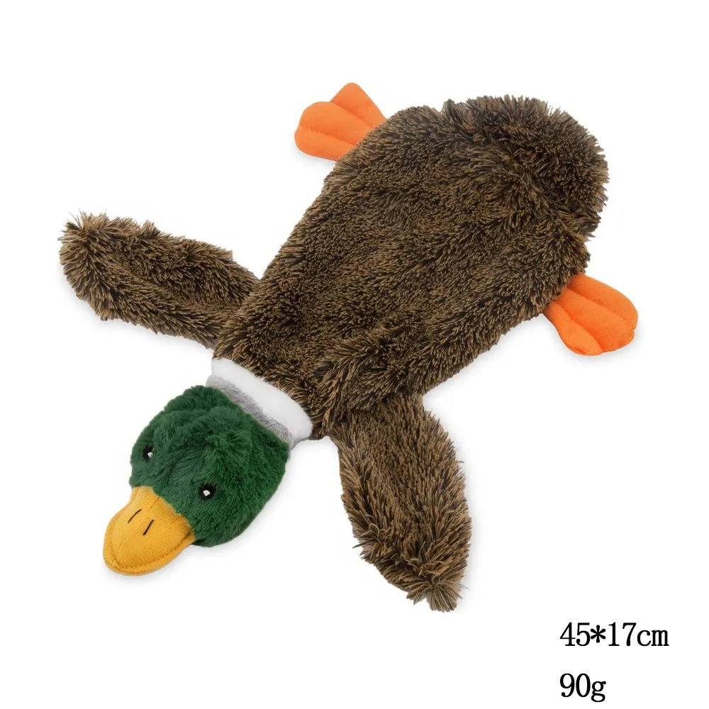 Green wild duck shaped stuffless plush dog toy with squeakers, shown with a plastic bottle next to it.