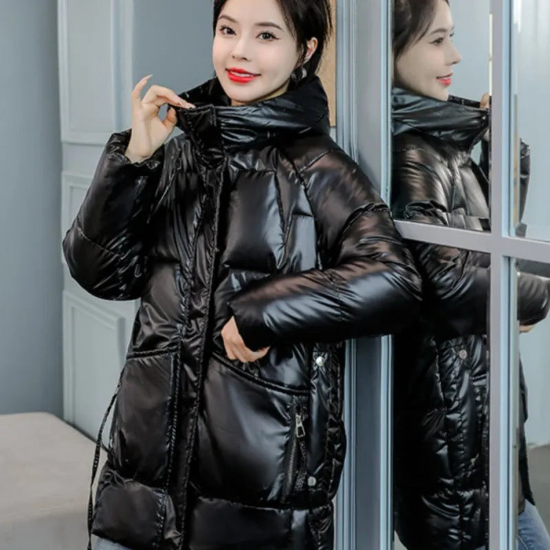 Women's loose thick hooded winter jacket in green colour shown on a model.