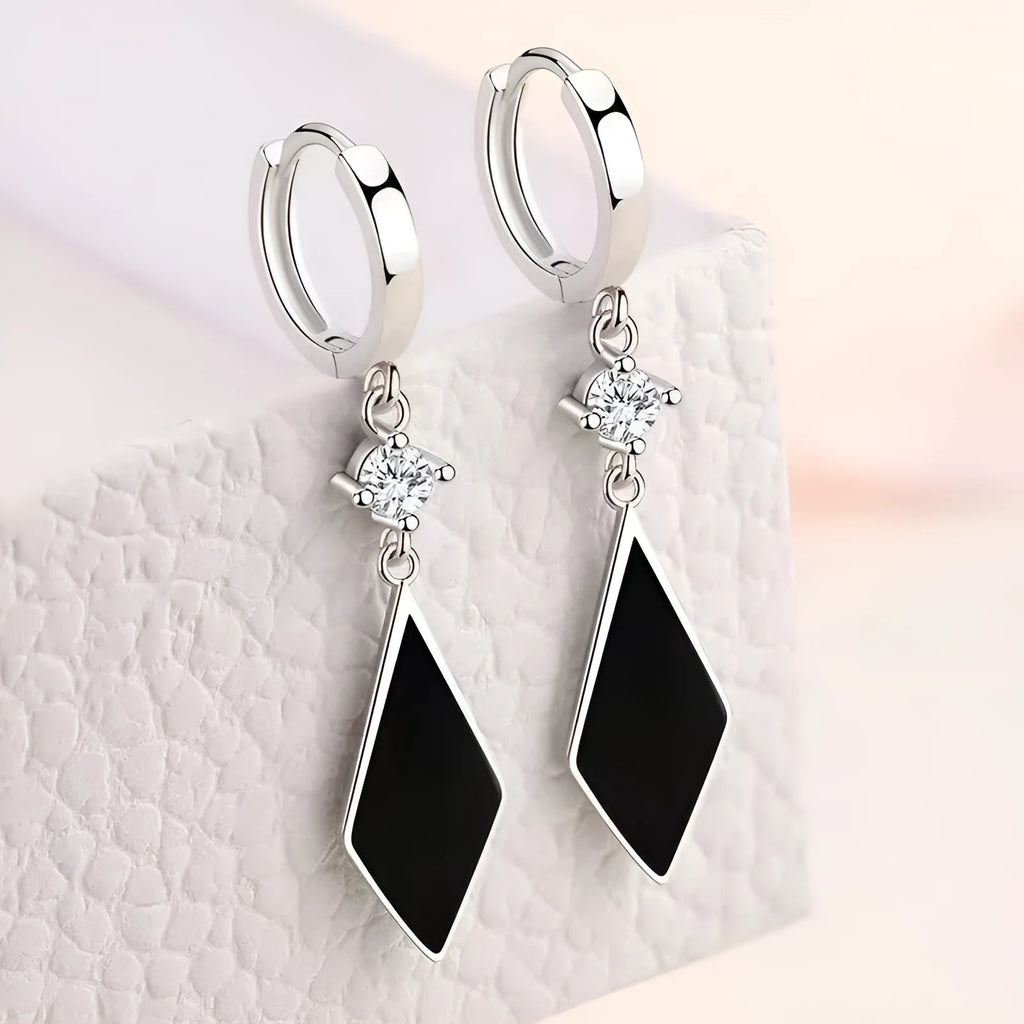 A pair of vintage silver diamond-shaped geometric clip-on earrings made from zinc alloy.