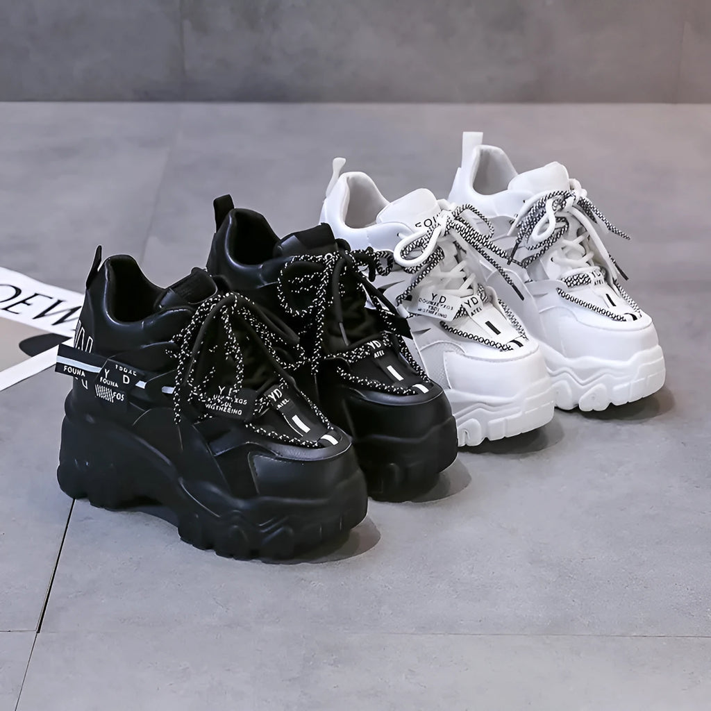 Women's white breathable mesh platform sports shoe with a cross strap on a rubber sole