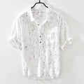 Men's loose fit short-sleeved polo shirt with lapel collar in black, laid flat.
