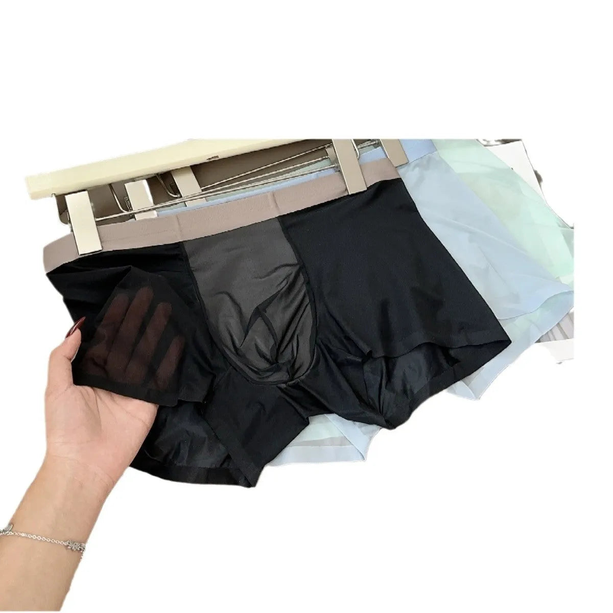 Ultra-thin seamless men's boxers in Ice Silk fabric showing honeycomb crotch design.