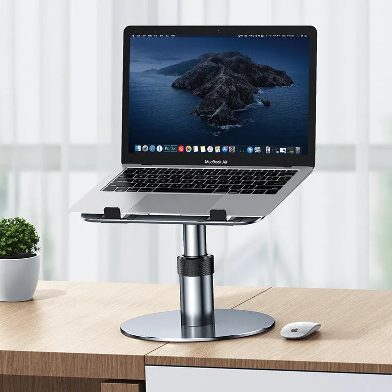 Silver adjustable laptop stand with 360-degree rotating base on a wooden desk.
