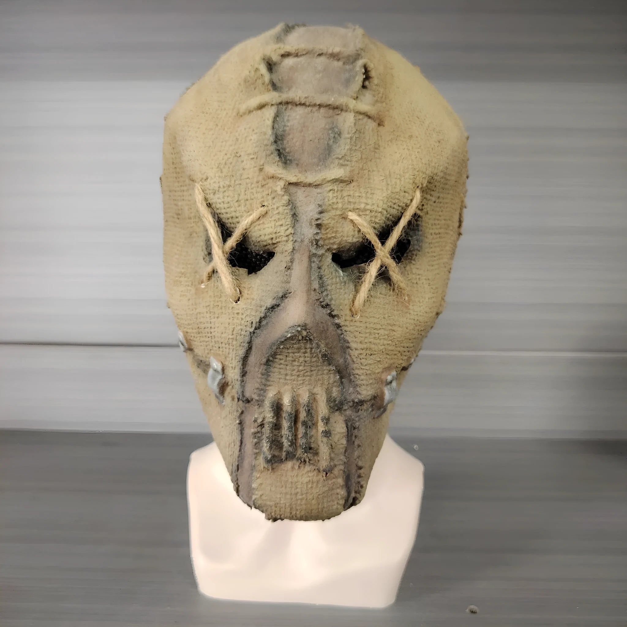 Latex horror mask with scar skull design worn as a full head cover for Halloween costumes