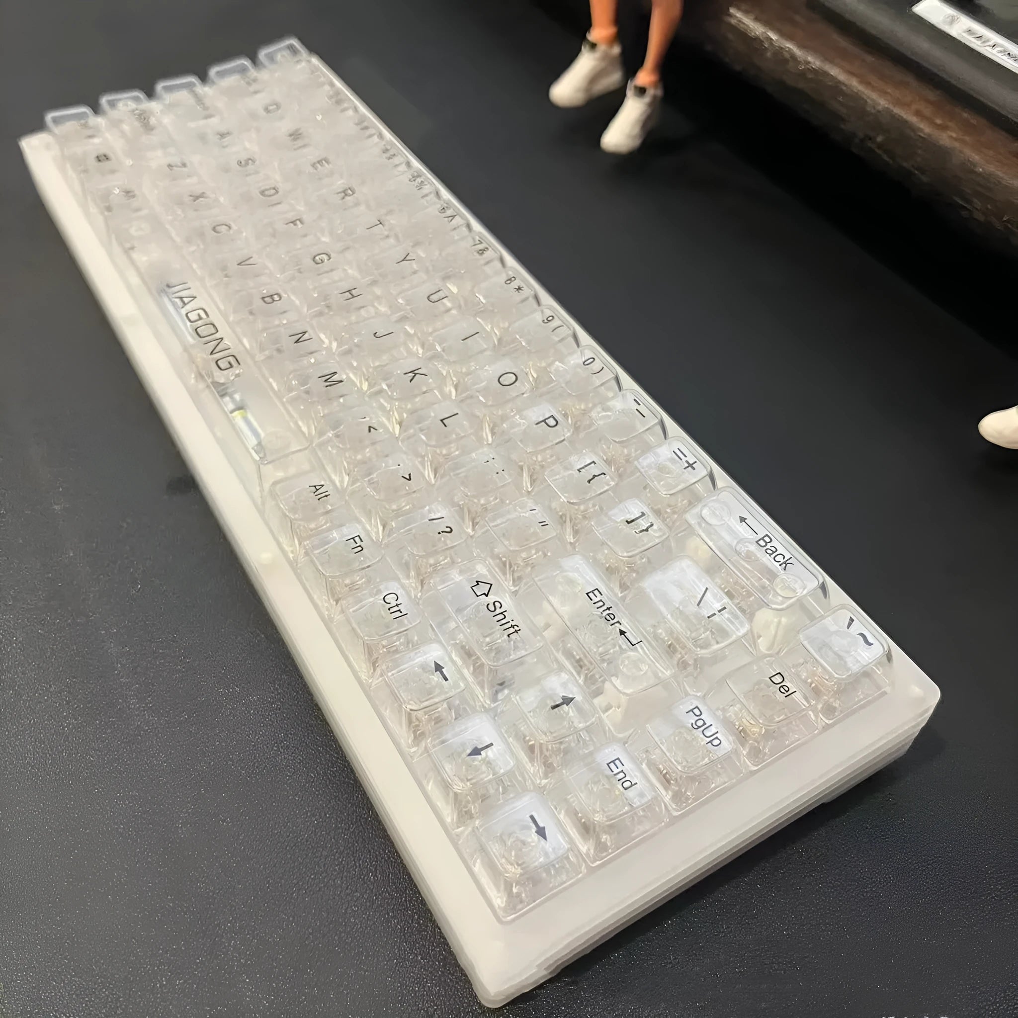 132 transparent plastic key caps arranged for a full-size keyboard layout