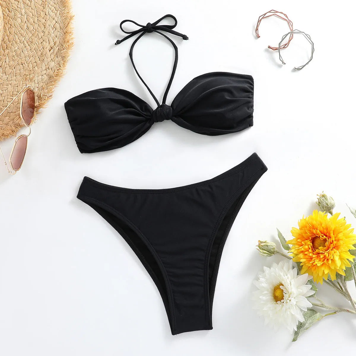 Black women's bikini set with lace-up tube top and matching briefs on white background