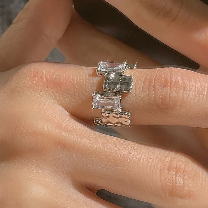 Silver geometric cross ring with open zircon gemstone setting and three-dimensional decoration