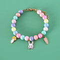 Pet wearing a resin headdress, collar, necklace, and bracelet set in a macaron colour with moon and star designs.