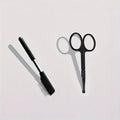 Black pet grooming brush with soft silicone bristles for gentle eye cleaning on dogs and cats