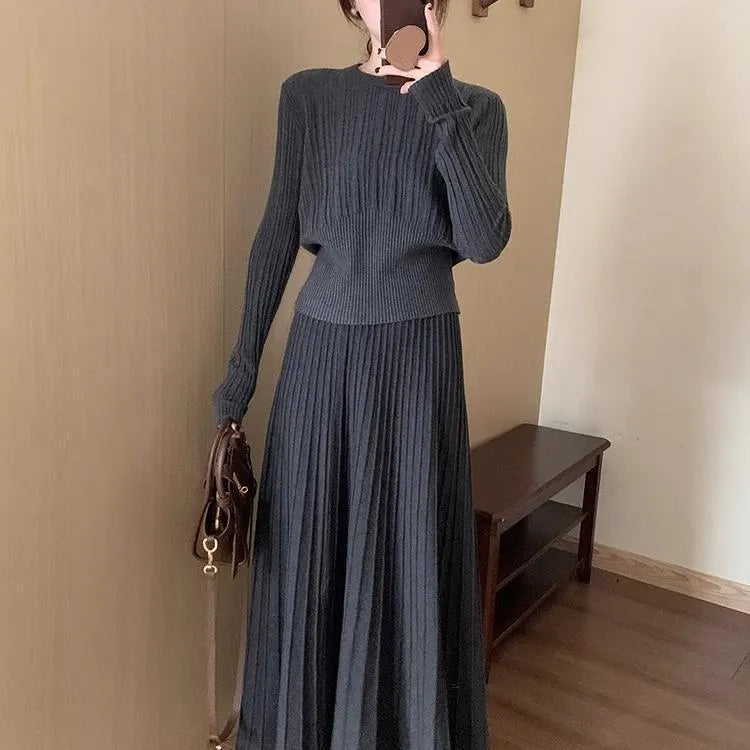 Women's dark grey knitted dress suit with 3D patterning and ethnic collage stitching, showing sweater and skirt two-piece set