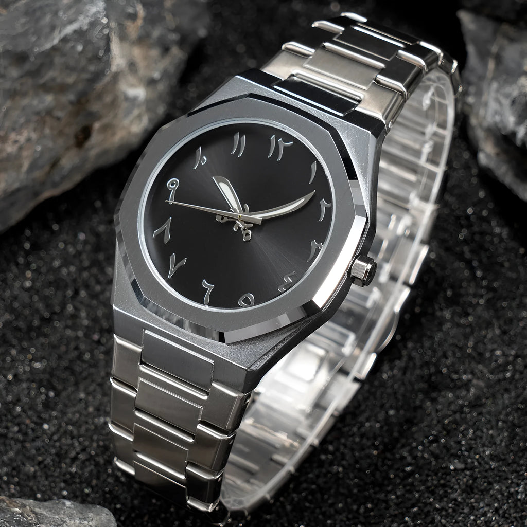Men's business quartz watch with a steel bracelet and a black and silver dial on a wrist.