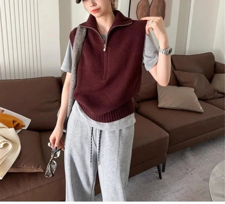 Woman's sleeveless half-zip knit vest with a 3D textured pattern in a solid colour.