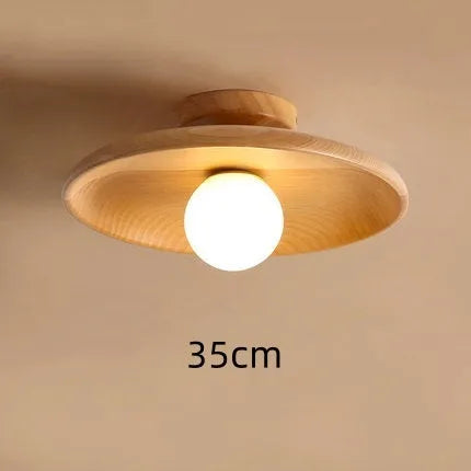 Solid wood ring ceiling lamp with glass shade in modern minimalist design.