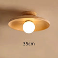 Solid wood ring ceiling lamp with glass shade in modern minimalist design.