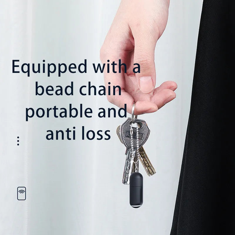 Small black capsule infrared remote control adapter for smartphone.