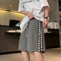 Men's black baggy track pants with loose fit design and elastic waistband for sports wear