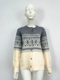 Grey alpaca wool women's cardigan with pink diamond knit contrast sleeves.