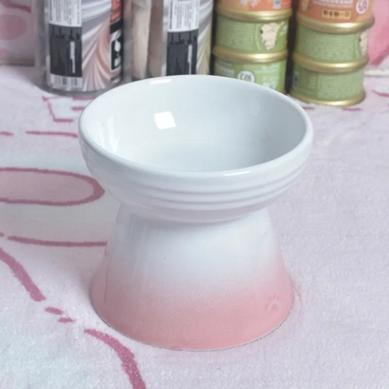 A heavy ceramic pet bowl with a raised high foot base and a built-up black chin guard.