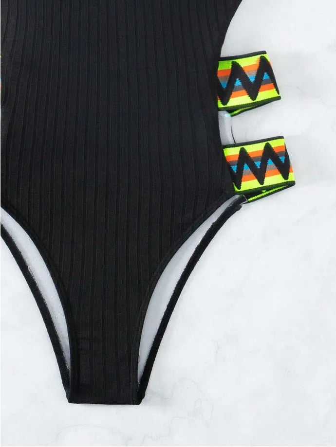 Solid black and orange women's one-piece polyester swimsuit bikini on a white background.