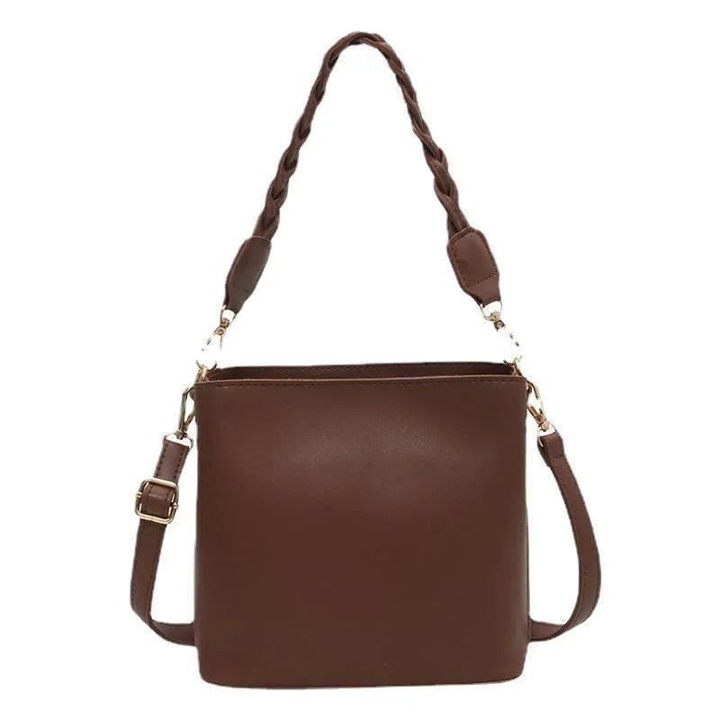 Retro woven PU bucket bag in khaki colour with crossbody strap shown in model shot