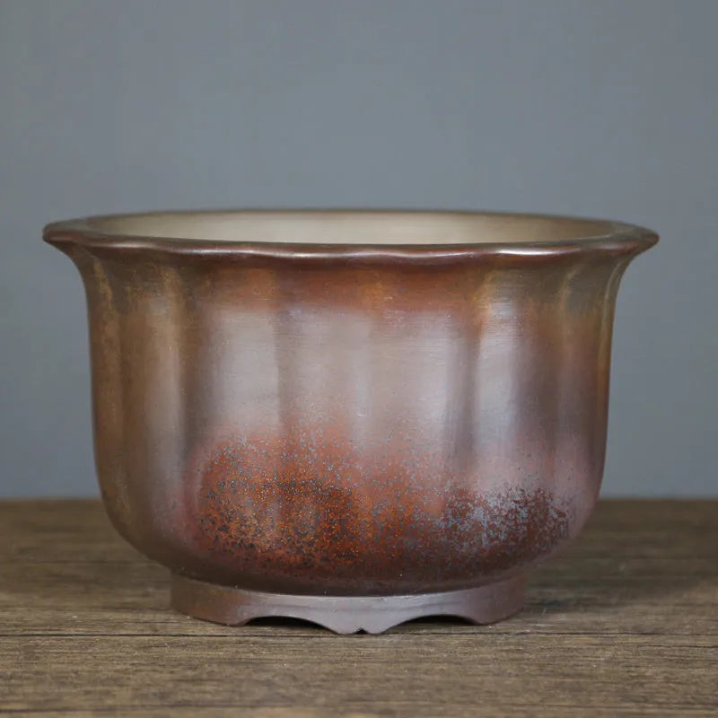 Indoor antique carved purple sand ceramic bonsai pot in classical style with wood burning finish.