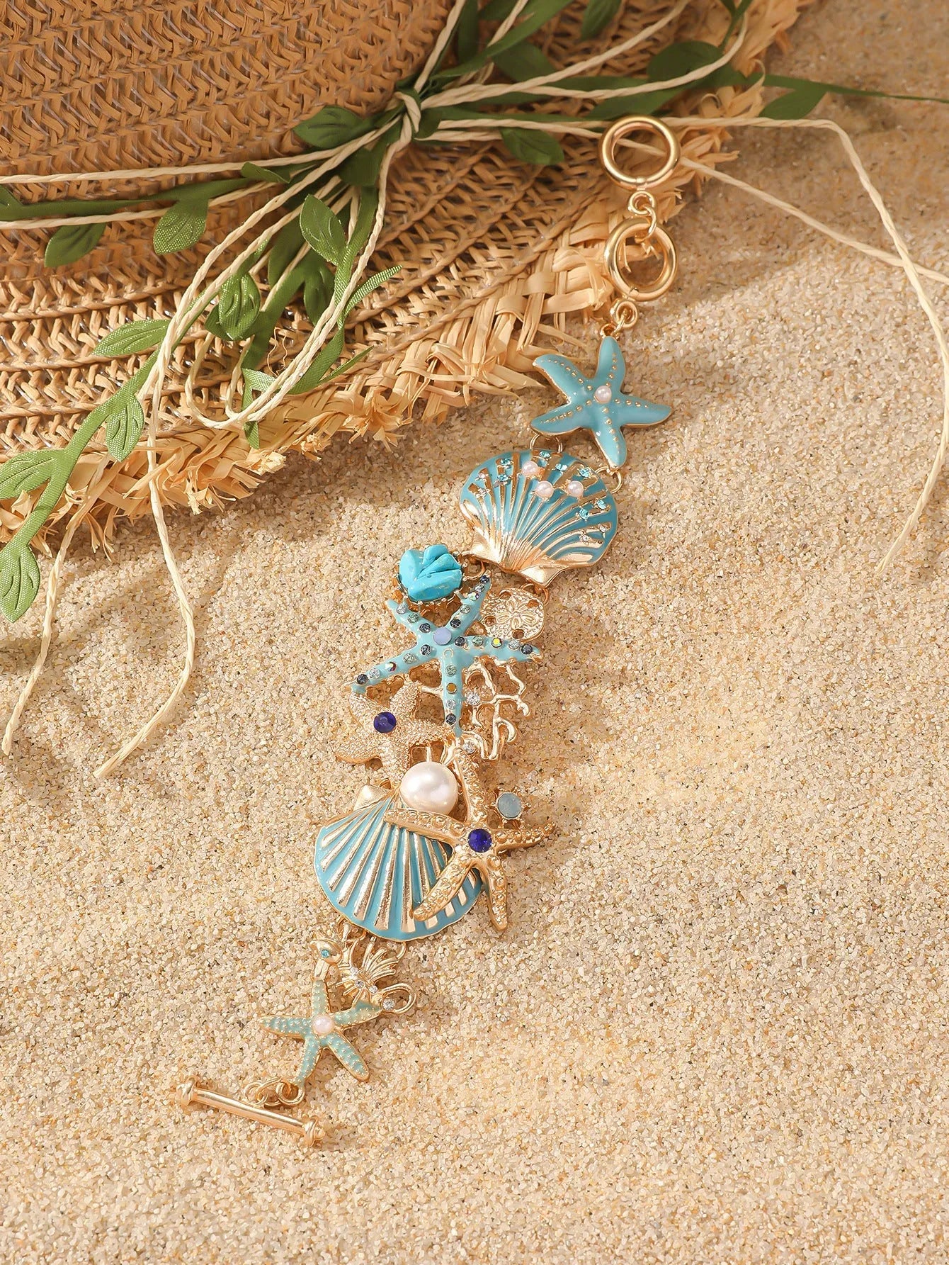 Alloy nautical bracelet with starfish, marine shell and boat anchor charms in turquoise colour