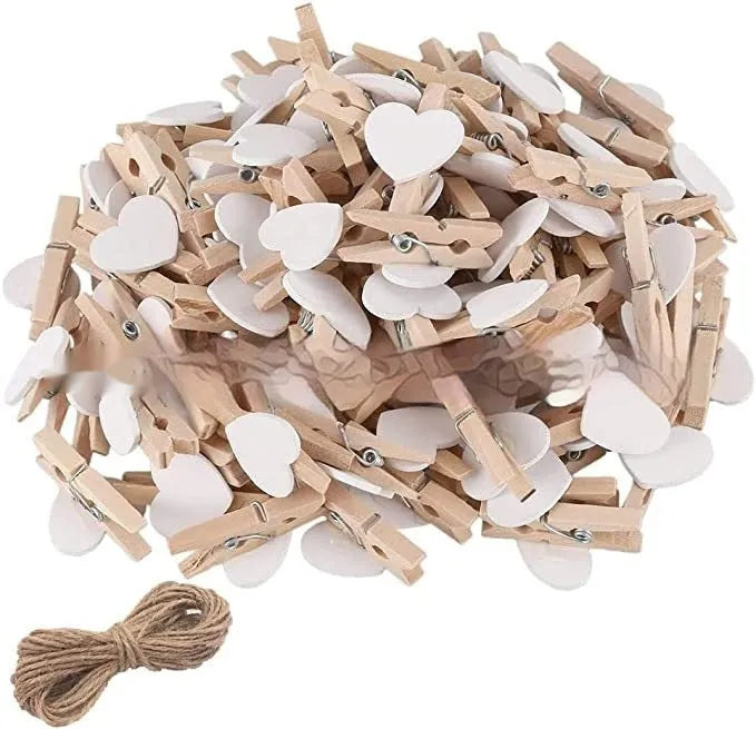 Five wooden heart-shaped hair clips in different colours on white background