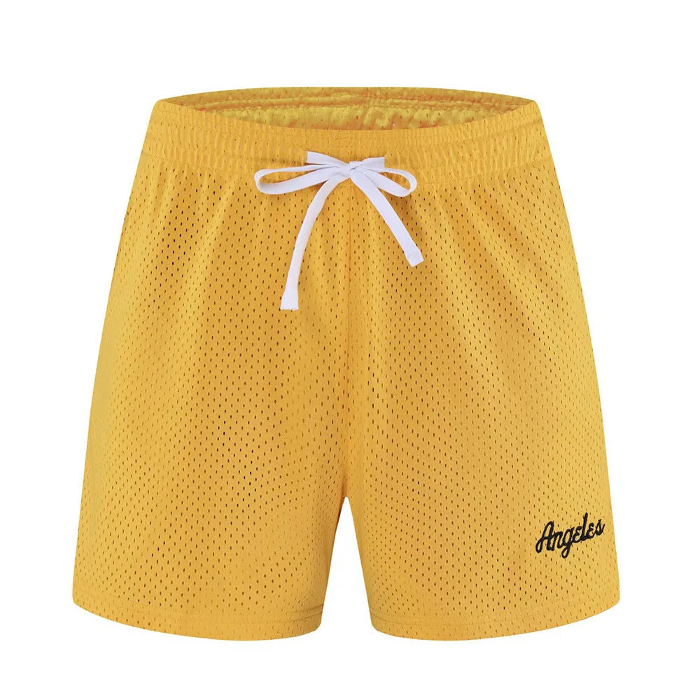 Men's double-layer mesh shorts in sports purple, showing the textured fabric and sporty design.