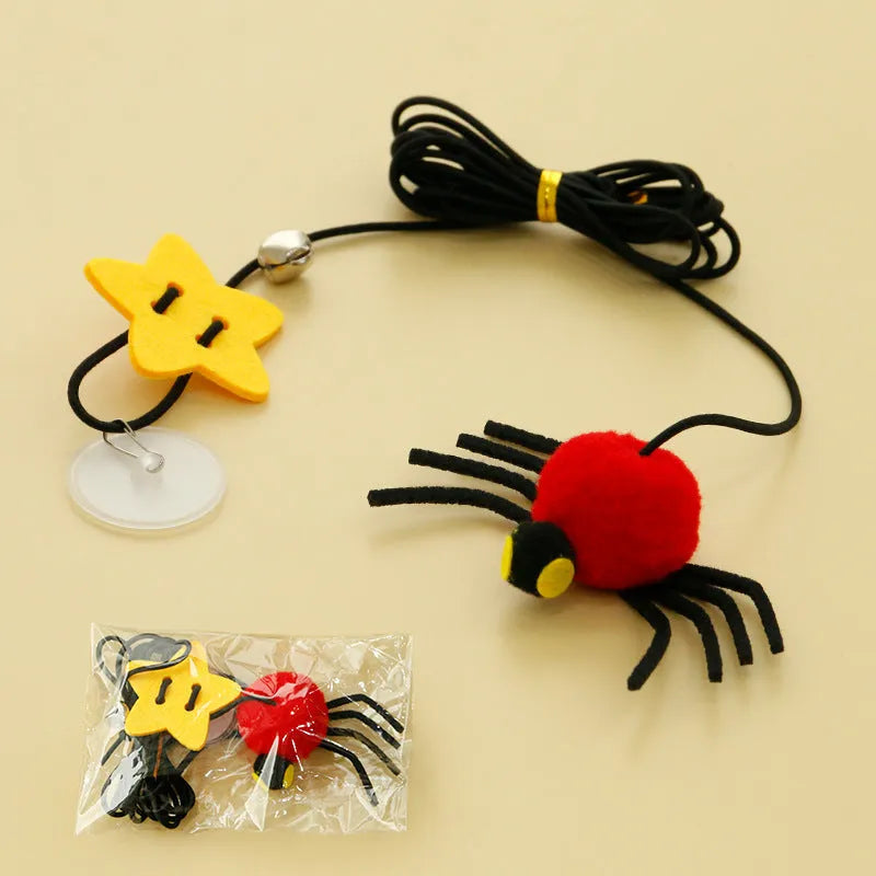 Red and yellow cat door toy with elastic rope, feather, bell, and spider dangling for interactive play.