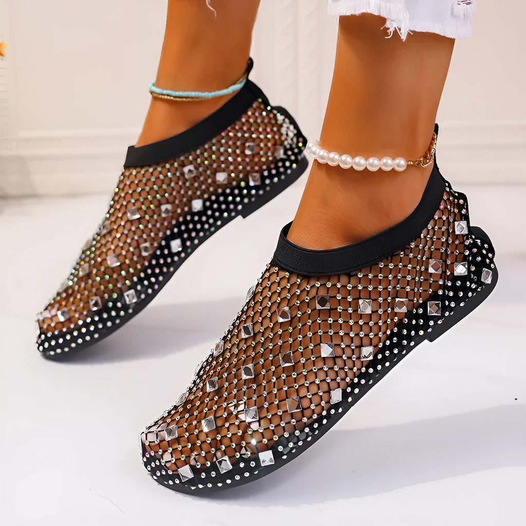 Women's flat sandals with colourful rhinestones on a mesh upper and a rubber sole.