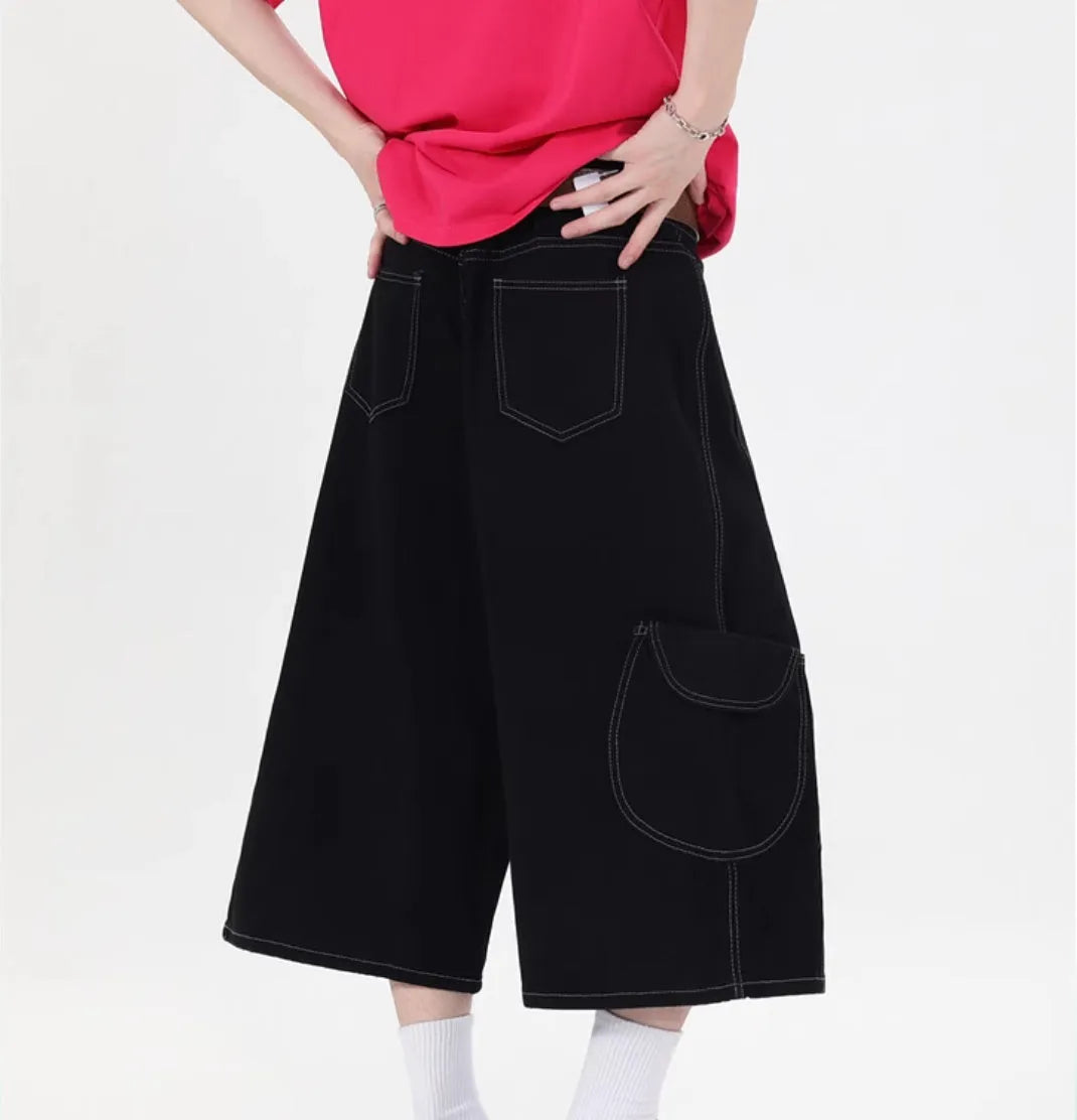 Retro black denim wide-leg shorts with multiple pockets on a mid-waist fit model.