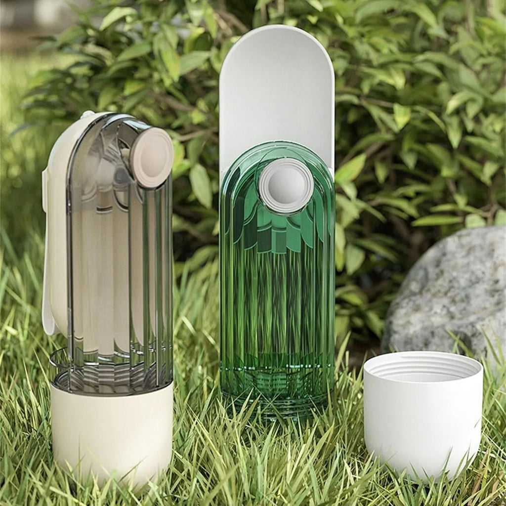 Foldable beige dog water bottle with food dispenser tray extended for drinking outdoors